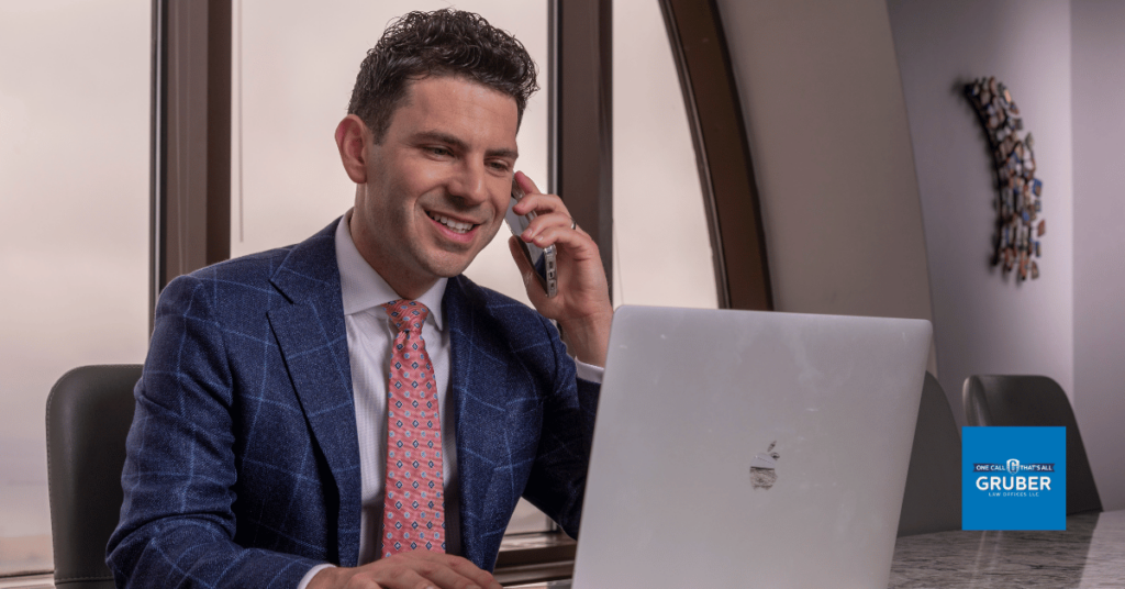 Car accident attorney Steven Gruber on the Phone and laptop