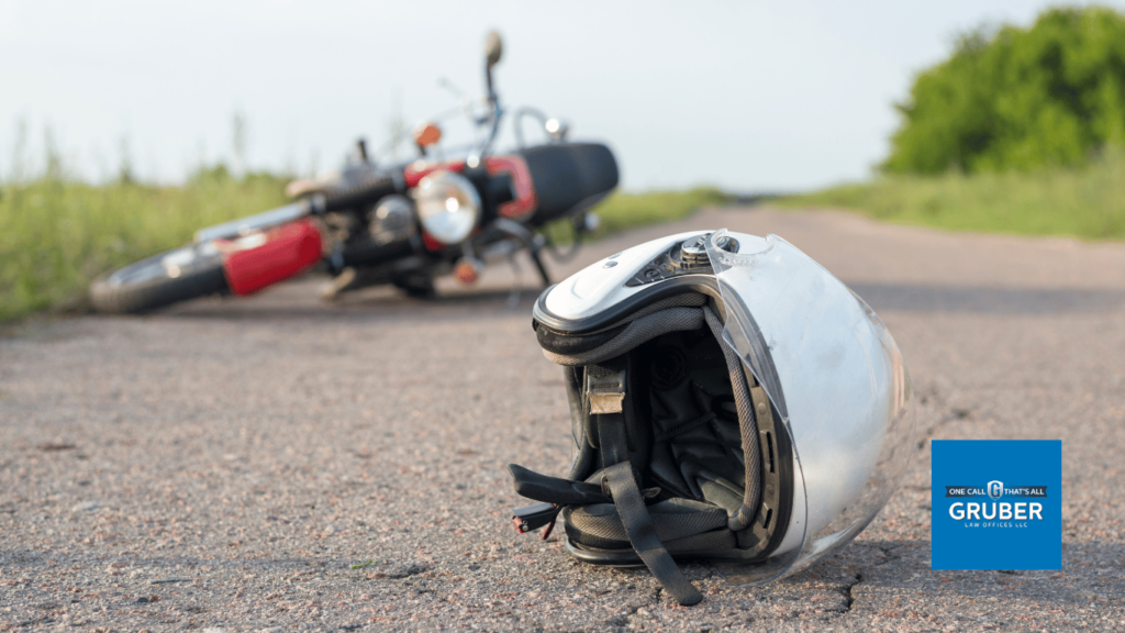 motorcycle and helmet on the road after a crash - Gruber Law