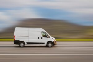 A delivery cargo van drives down a highway. While there is no way to know for sure what the average DHL truck accident settlement is, you still may be able to recover damages from the crash you were in. Consult with our truck accident lawyer today.