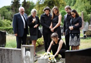 A family lays flowers on a loved one's grave and wonders how long it takes to settle a wrongful death case.