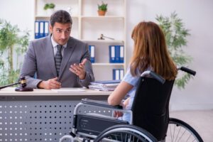 A truck accident victim sits at a desk across from her Wisconsin lawyer to ask if her truck accident settlement is taxable.