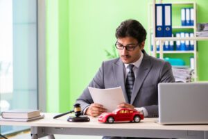 Man in a suit looks at papers and wonders: Are car accident settlements taxable in Wisconsin?