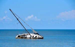 A grounded sailboat waits for help after an accident, leaving people wondering what to do after a boating accident in Wisconsin.